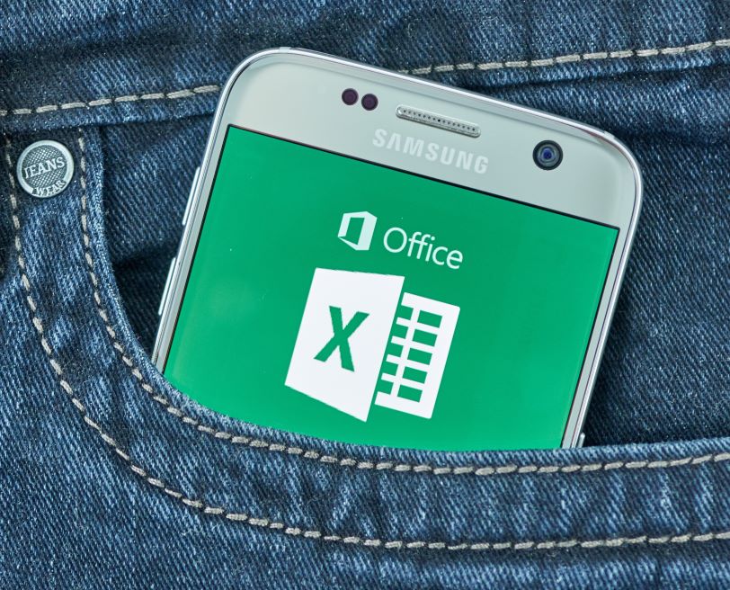 Microsoft Excel program icon in back pocket of a pair of jeans